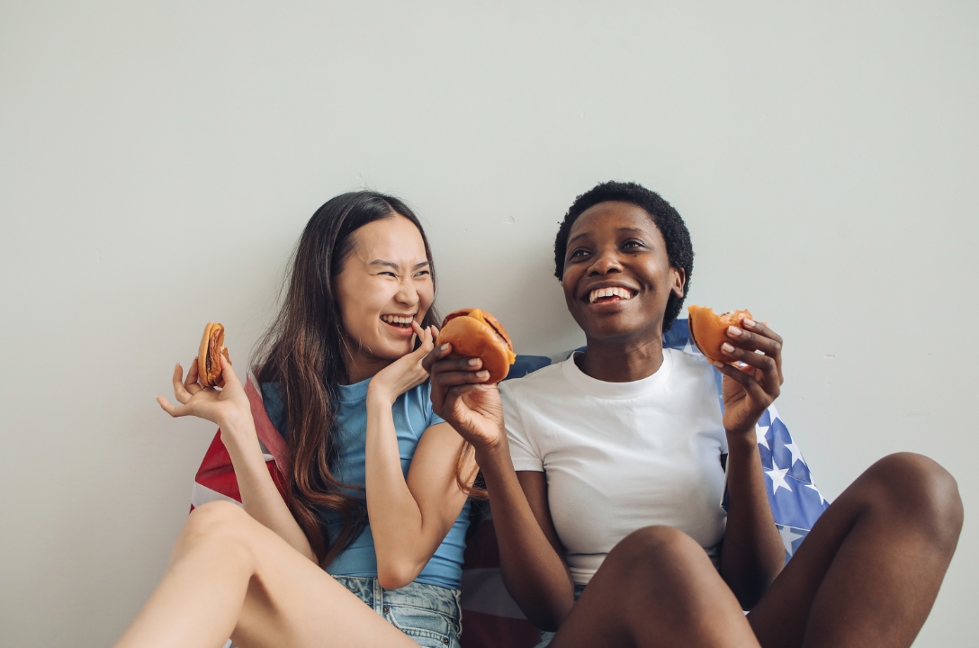 Two girls enjoying a burger