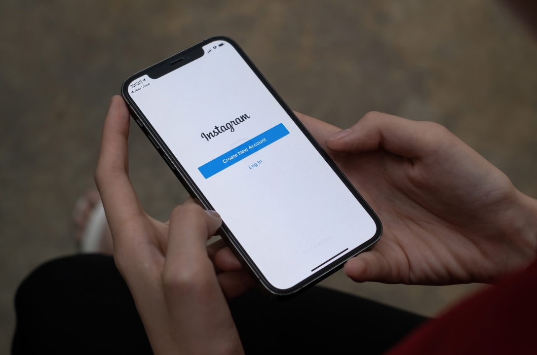 hands holding a phone with instagram log in page open