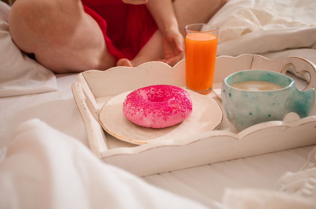 Secretly eating a doughnut in bed